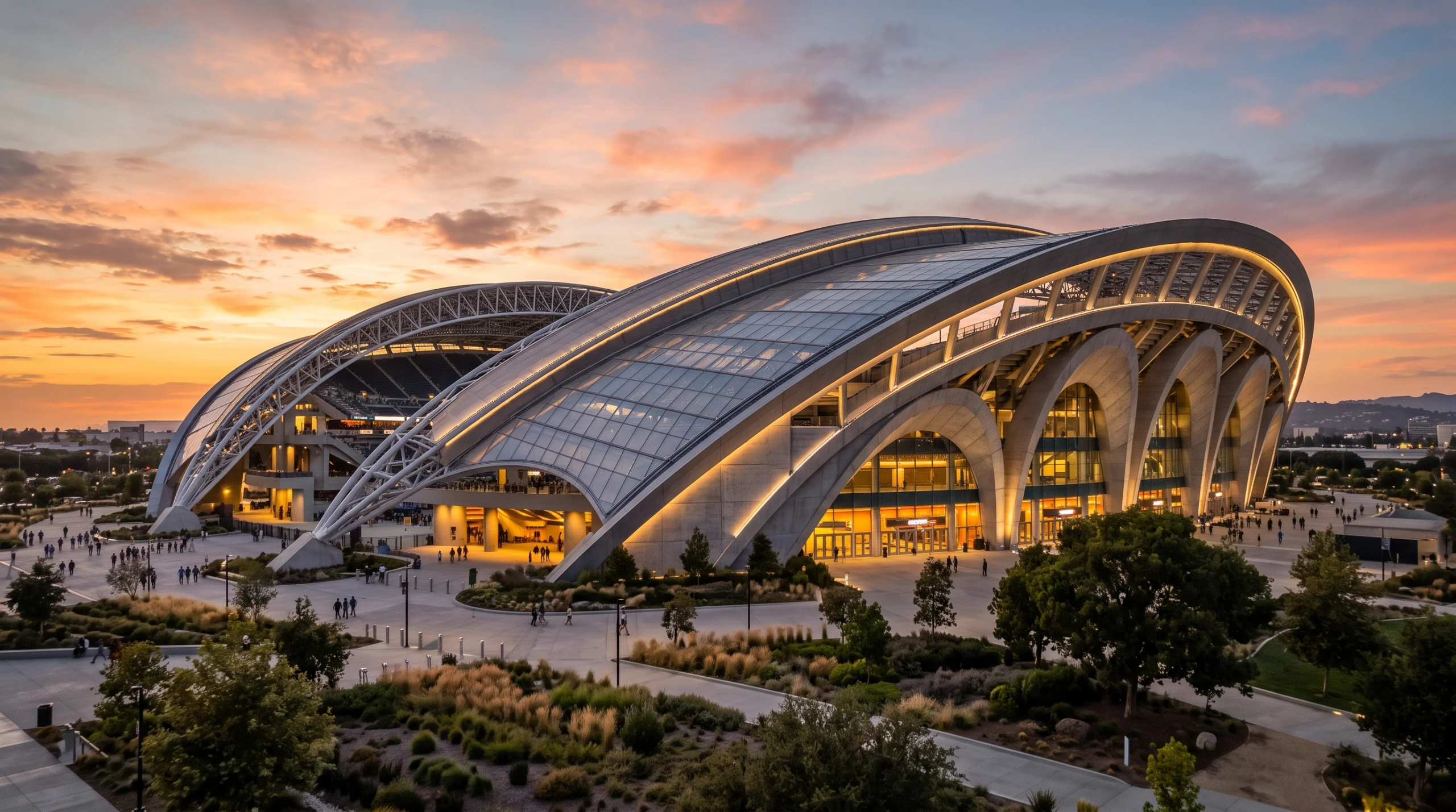 Vista de una gran estructura moderna con techos curvos de vidrio y acero iluminados al atardecer, representando la ambición arquitectónica monumental y la maestría estructural de vanguardia que RBA Residences aplica en sus proyectos en Zapopan.
